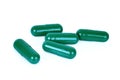 Green capsule pills isoated on white