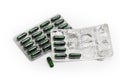 Green capsules in full packing and in started blister packing Royalty Free Stock Photo