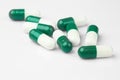 Green capsules and white antibiotic pills Royalty Free Stock Photo