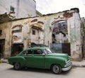 Green car on eroded havana street, cuba Royalty Free Stock Photo