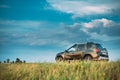 Green Car Renault Duster Suv Parked On Field Country Road.