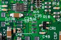 Green card computer board with brown microcircuits and various electronic components, top view Royalty Free Stock Photo