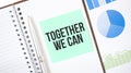Green card on the white notepad. Text Together We Can. Business concept Royalty Free Stock Photo