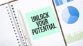 Green card on the white notepad. Text Unlock Your Potential. Business concept Royalty Free Stock Photo