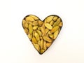 Green Cardamom pods defined heart shaped on white background, Top view Royalty Free Stock Photo