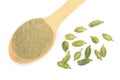 Green cardamom seeds and powder in a wooden spoon isolated on white background. Top view. lay flat Royalty Free Stock Photo