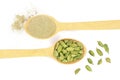 Green cardamom seeds and powder in a wooden spoon isolated on white background. Top view. lay flat Royalty Free Stock Photo