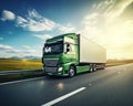 green cargo truck is traveling on the highway during the daytime.