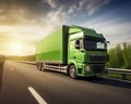 green cargo truck is traveling on the highway during the daytime.