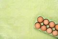 Green carton of different eggs. Easter background