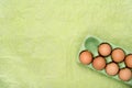 Green carton of different eggs. Easter background