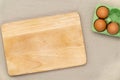 Green carton of eggs and cutting board. Easter background