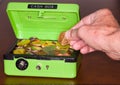 Green cash box with gold and silver coins Royalty Free Stock Photo