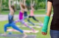 Green cast on hand and arm on blurred background woman fitness g