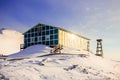 Green catholic church with the bell tower standing on the snow hill, Ilulissat city, Greenland