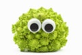 Green cauliflower with googly eyes on white background