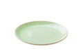Green ceramic round plate isolated over white background. perspective view Royalty Free Stock Photo