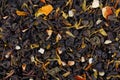 Green Ceylon tea with dry flowers and candied orange background.