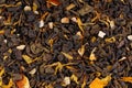 Green Ceylon tea with dry flowers and candied orange background.