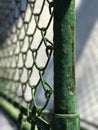 A rusty green fence in the middle of a suburban winter Royalty Free Stock Photo