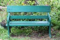 Green chair or bench on ground in public park and nobody. Royalty Free Stock Photo