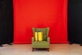 Green vintage chair in the interior of the red black room Royalty Free Stock Photo