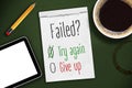 Green chalkboard with sketchbook, tablet and cup of coffee with message Failed? Try again or give up! Royalty Free Stock Photo