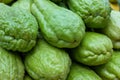 Green chayote pile closeup photo. Ripe vegetable on market. Tropical vegetable from south Asia or latin America