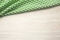 Green checered cloth on wooden table top view. Picnic towel on light wood texture background empty advertisement space Royalty Free Stock Photo