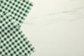 Green checkered tablecloth on white marble background, top view. Space for text Royalty Free Stock Photo