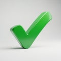 Green checkmark stands on a light gray surface casting a subtle Royalty Free Stock Photo