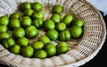 Green cherry plum in white straw plate Royalty Free Stock Photo