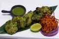 green chicken tikka. mint, spinach and yoghurt marinated spiced tandoori chicken, indian cuisine