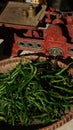 Green chili pepper in bamboo basket. Exposed to the morning sun