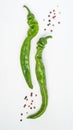 Green chili peppers and pepper peas on a white background Royalty Free Stock Photo