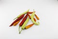Green chili, red chili Yellow peppers placed on a white background Royalty Free Stock Photo
