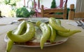 Green Chilli pepper on a garden table. Mediterranean food in a plate ready to eat. Raw Organic. Home Chair