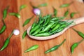 Green Chilli peppers on wooden spoon