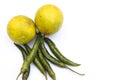 Green chillies and lemon on white background Royalty Free Stock Photo