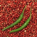 Green chillies on red pepper, close-up