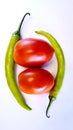 green chillies and red tomatoes with white background