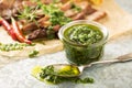 Green chimichurri sauce with grilled steak