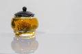 Green Chinese tea flower bud blooming in glass teapot. on white background Royalty Free Stock Photo