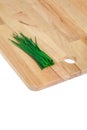 Green chives on wooden chopping board Royalty Free Stock Photo