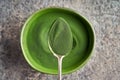 Green chlorella algae powder on a metal spoon. Healthy food concept Royalty Free Stock Photo