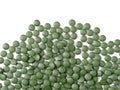 Green chlorella and spirulina pills. Nutritional supplement, healthy lifestyle, alternative natural medicine. Royalty Free Stock Photo