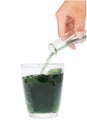 Green chlorophyll in glass and hands