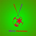 Green Christmas background with Christmas balls with red and purple snowflakes hanging on the white ribbon with color writing Merr Royalty Free Stock Photo