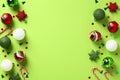 Green Christmas background. Frame borders made of baubles, Xmas decorations, candy canes, confetti. Flat lay, top view, copy space Royalty Free Stock Photo