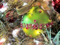 Green Christmas bulb with red crystals and velvet glitter ribbon, horizontal Royalty Free Stock Photo